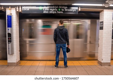 New York, NY, USA - May 23, 2019: Subway Train Canal Street Station Platform With A Man Standing By The Passing Train. The NYC Subway Is A Rapid Transit/transportation System In The City Of NY.