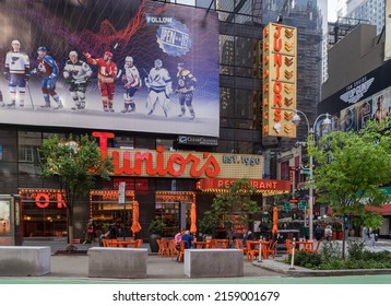 New York, NY - USA - May 20, 2022 Horizontal view of Times Square Junior's Restaurant. The Brooklyn-themed landmark located near the corner of Broadway and 45th St., is known for cheesecake.