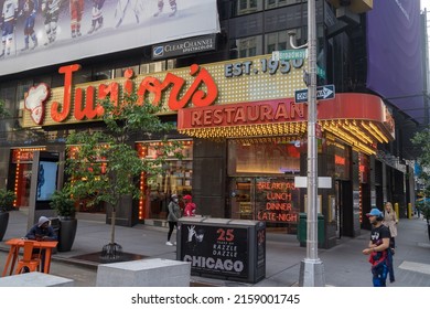 New York, NY - USA - May 20, 2022 Horizontal view of Times Square Junior's Restaurant. The Brooklyn-themed landmark located near the corner of Broadway and 45th St., is known for cheesecake.
