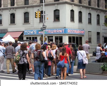 New York, NY, USA - September 13, 2008:  People head towards Tom's Restaurant which was used as the exterior shot for Monk's in sitcom Seinfeld during stop on Kramer’s Reality Tour run by Kenny Kramer