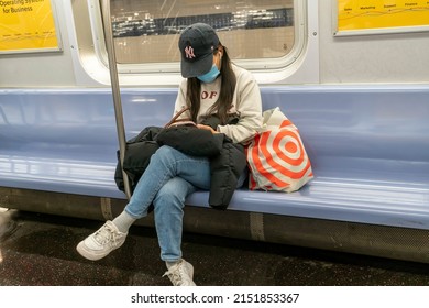 New York NY USA-April 30, 2022 A Subway Rider Distracted By Her Smartphone In New York