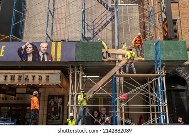 New York NY USA-April 4, 2022 Workers construct scaffolding over the Manhattan Theatre ClubÕs Samuel J, Friedman Theatre where How I Learned To Drive is being performed on a dark Monday