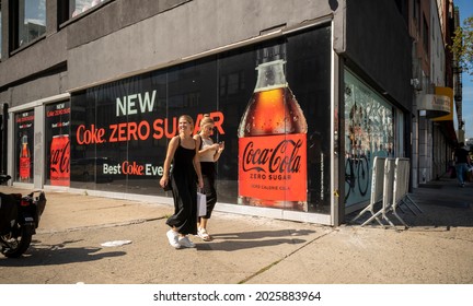 New York NY USA-August 15, 2021 Women Walk Past A Billboard Advertising The New Coke Zero Sugar In New York