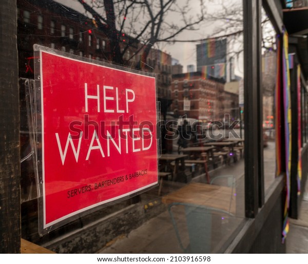 New York NY USA-January 9,\
2022 Help wanted sign in a restaurant window in HellÕs Kitchen in\
New York