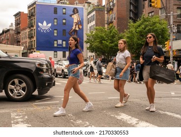 New York NY USA-June 18, 2022 Crowds Of Shoppers In Soho In New York Pass A Billboard For Gucci 