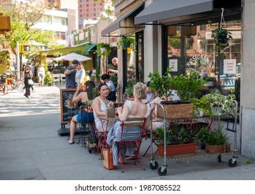 New York NY USA-June 6, 2021 Al Fresco Dining In The Shade During The Hot Weather At A Sidewalk Cafe In The New York Neighborhood Of The Greenwich Village