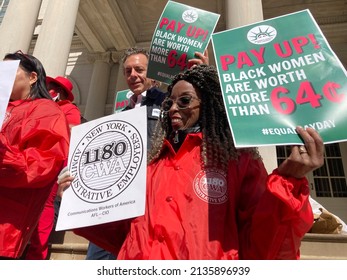 New York NY USA-March 15, 2022 Activists, community leaders, union members and politicians gather on the steps of City Hall in New York to rally against pay disparity on Equal Pay Day.