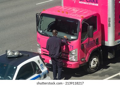 New York NY USA-March 22, 2022 A Traffic Agent Tickets A Moving Van In The Chelsea Neighborhood Of New York