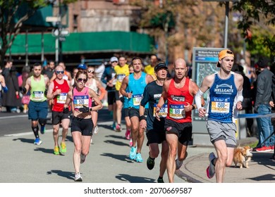 New York NY USA-November 7, 2021 Runners pass through Harlem in New York near the 22 mile mark near Mount Morris Park in the 50th running of the TCS New York City Marathon