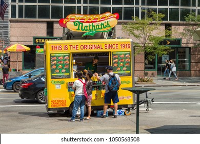 New York, NYC, USA - August 27, 2017: Street Food Colorful Vendor Cart With Customers On Manhattan Street.