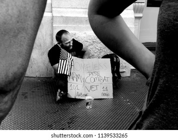 NEW YORK, NY-JULY 2018: A homeless veteran looks for help on a sidewalk in the Soho section of Manhattan. 