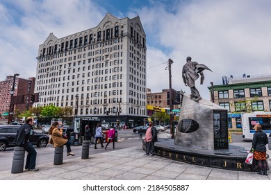 New York, NYUSA - 05-07-2016: Adam Clayton Powell Statue And Shops In Harlem.