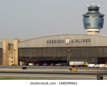 New York, NY/USA-5/30/16: A New Air Traffic Control Tower Looms Over A Weathered American Airlines Hangar Built In The Mid 20th Century At La Guardia Airport In Queens.                              