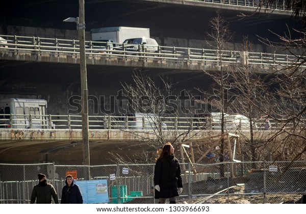 New York NY/USA-February 2, 2019 The aging\
Brooklyn-Queens Expressway (BQE) running on two levels beneath the\
popular Brooklyn Heights Promenade is seen from Brooklyn Bridge\
Park in New York