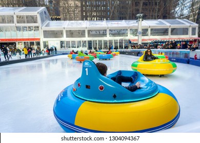New York NY/USA-February 3, 2019 Visitors to the Winter Village ice skating rink at Bryant Park try out the new bumper cars attraction