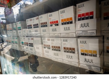 New York NY/USA-January 13, 2019 A Selection Of The Popular Juul Brand Vaping Supplies On Display In The Window Of A Vaping Store In New York