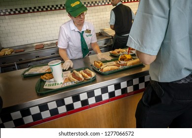 New York NY/USA-January 6, 2019 Workers prepare customers' meals in the stand-alone Nathan's Famous location in the Bay Ridge neighborhood of Brooklyn in New York on its last day