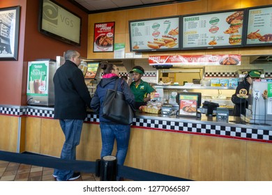 New York NY/USA-January 6, 2019 Diners place their orders in the stand-alone Nathan's Famous location in the Bay Ridge neighborhood of Brooklyn in New York on its last day