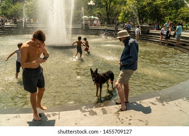 New York NY/USA-July 19, 2019 New Yorkers and visitors frolic in the fountain in Washington Square Park in Greenwich Village in New York