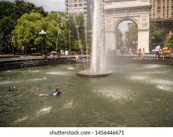 New York NY/USA-July 20, 2019 New Yorkers and visitors frolic by the fountain in Washington Square Park in Greenwich Village in New York