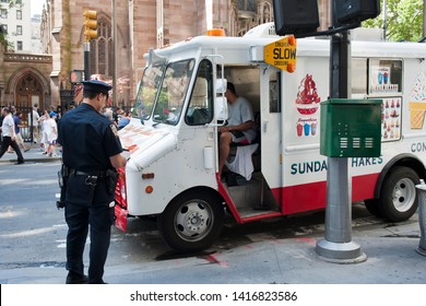 New York NY/USA-July 9, 2011 An NYPD Officer Tickets A Soft Ice Cream Truck On Broadway In Lower Manhattan In New York