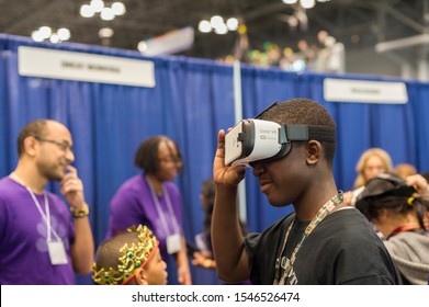 New York NY/USA-March 13, 2016 A visitor to the Comcast NBCUniversal booth wears a Samsung Gear VR Virtual reality device at a Career Expo held at the FIRST Robotics NYC Championship