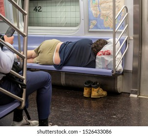 New York NY/USA-October 8, 2019 A Homeless Man Sleeps On A Subway Train In New York