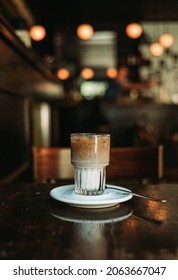 New York, New York - OCTOBER 18, 2021: A perfectly made coffee is served at a diner. The coffee is separated with the milk at the bottom. The colors of the coffee pop in t he close up shot.  