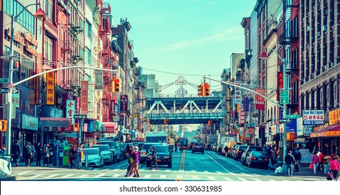 NEW YORK - OCTOBER 21, 2015: Busy Street With Crowded Chinese Stores In Chinatown, Manhattan, New York. The Neighborhood Is Home To The Largest Enclave Of Chinese People In The Western Hemisphere.