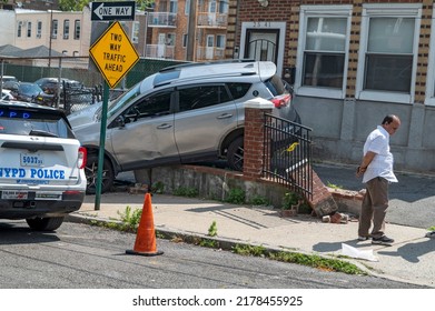 New York Police Department (NYPD) Officers Survey The Damage After A Car Went Out Of Control And Crash Into A House In Astoria Neighborhood On July 14, 2022 In New York City.