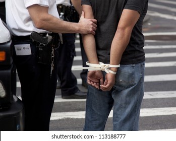 NEW YORK - SEPT 17: Plastic handcuffs on an unidentified man being arrested during the 1yr anniversary of the Occupy Wall St protests on September 17, 2012 in New York City, NY.