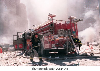NEW YORK - SEPTEMBER 11:  A New York City firefighter carries a fire hose as he works near the area known as Ground Zero after the collapse of the Twin Towers September 11, 2001 in New York City.