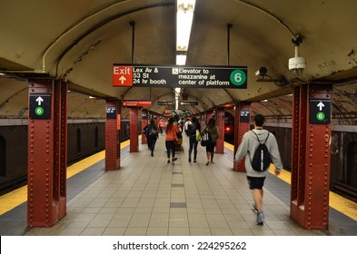 NEW YORK - SEPTEMBER 21, 2014: MTA Subway Train Station Platform With People Traveling In New York. The NYC Subway Is A Rapid Transit/transportation System In The City Of NY.