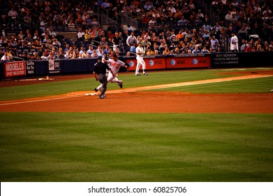 NEW YORK - SEPTEMBER 7: Orioles Pitcher Jake Arrieta Beats Yankees Shortstop Derek Jeter To First Base As Umpire John Hirschbeck Readies To Make The Call September 7, 2010 In New York, NY