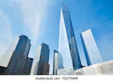 NEW YORK - SEPTEMBER 8: One World Trade Center skyscraper surrounded by glass buildings, blue sky in a sunny day on September 8, 2016 in New York. The Freedom Tower is the sixth tallest building.