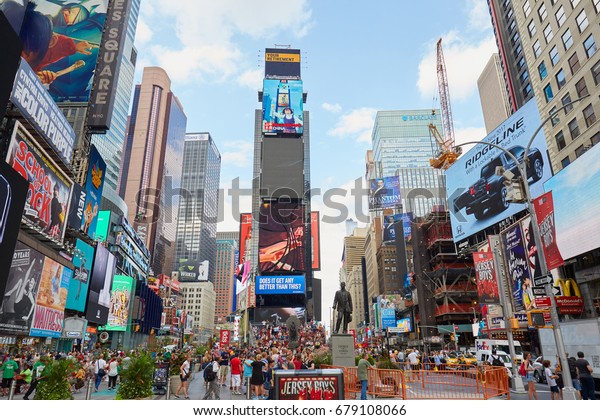 NEW YORK - SEPTEMBER 9:\
Times Square view with people and advertising billboards on\
September 9, 2016 in New York. Thousands of tourists pass through\
Times Square daily.