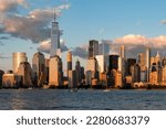 New York skyscrapers at sunset, office buildings and waterfront, financial corporation and world business center. Manhattan skyline in the evening