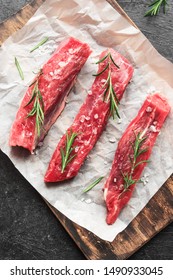 New York Strip Steak With Salt And Rosemary On Black Background, Top View, Close Up. Uncooked Raw Beef Strip Steaks.