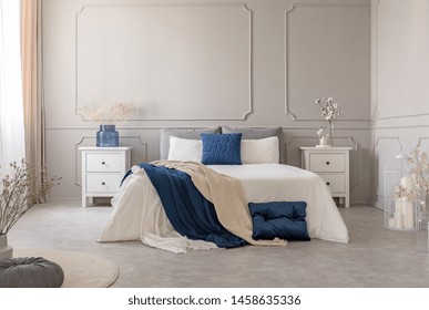 New york style bedroom interior with symmetric design, copy space on empty grey wall