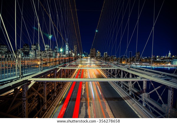 New York Traffic in Motion. Brooklyn\
Bridge During Heavy Traffic Time. New York,\
USA.