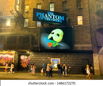 NEW YORK – UNITED STATES OF AMERICA, , AUGUST 17 2019  : The advertising billboard of famous show on the old building named "The Phantom of the opera", New York, USA AT NIGHT