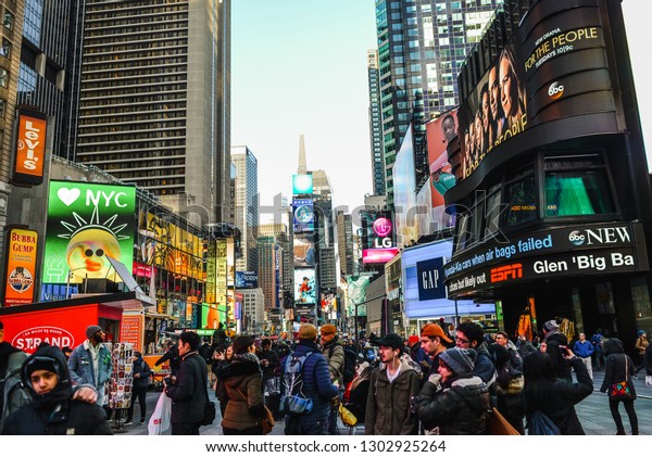 NEW\
YORK / UNITED STATES OF AMERICA - CIRCA March, 2018: Times Square\
during a day filled with people passing by No.\
16