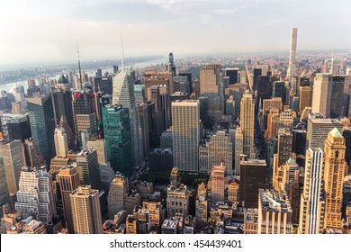 NEW YORK, UNITED STATES - JUN 22, 2016: New York City Manhattan street aerial view with skyscrapers, pedestrian and busy traffic. Sun at sunset.