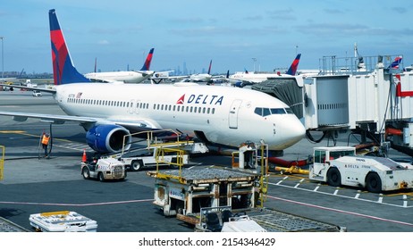 NEW YORK, NEW YORK  UNITED STATES - May 3, 2022: With the New York City skyline in the distance, a Delta Airlines 737-800 is prepared for it's next flight at John F Kennedy International Airport.
