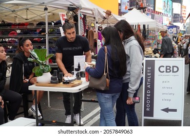 New York, New York  United States - October 9, 2021: CBD Stand At An Outdoor Street Fair. Two Young Women Speaking With Salesperson