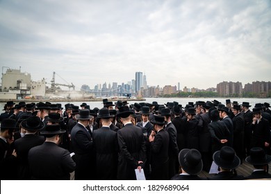 NEW YORK, UNITED STATES - Sep 24, 2020: Hasidic Jews from the Williamsburg neighborhood of Brooklyn, New York, gather for the tashlich New Year's ceremony at the shore of the East River.