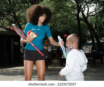 New York, New York  United States - September 18, 2022: Tennis Pro Coaching Young Black Boy In Harlem