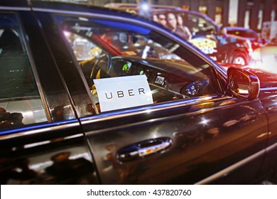 New York, US - August 23, 2015.  Uber car service on the streets of New York at Night. With selective focus on Uber logo.
