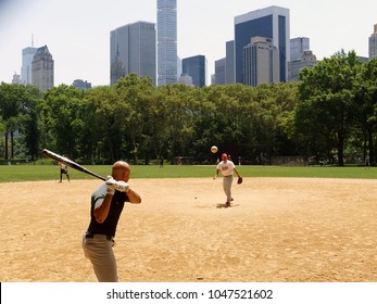 New York, US - June 26. 2016: Two Men Playing Baseball In Central Park In The Summer