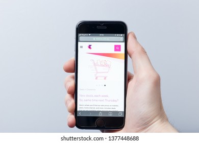 New York / USA - 04.14.2019: A hand holding a smartphone which displays Telstra logo on the official website homepage. Telstra logo visible on smartphone screen. Illustrative editorial